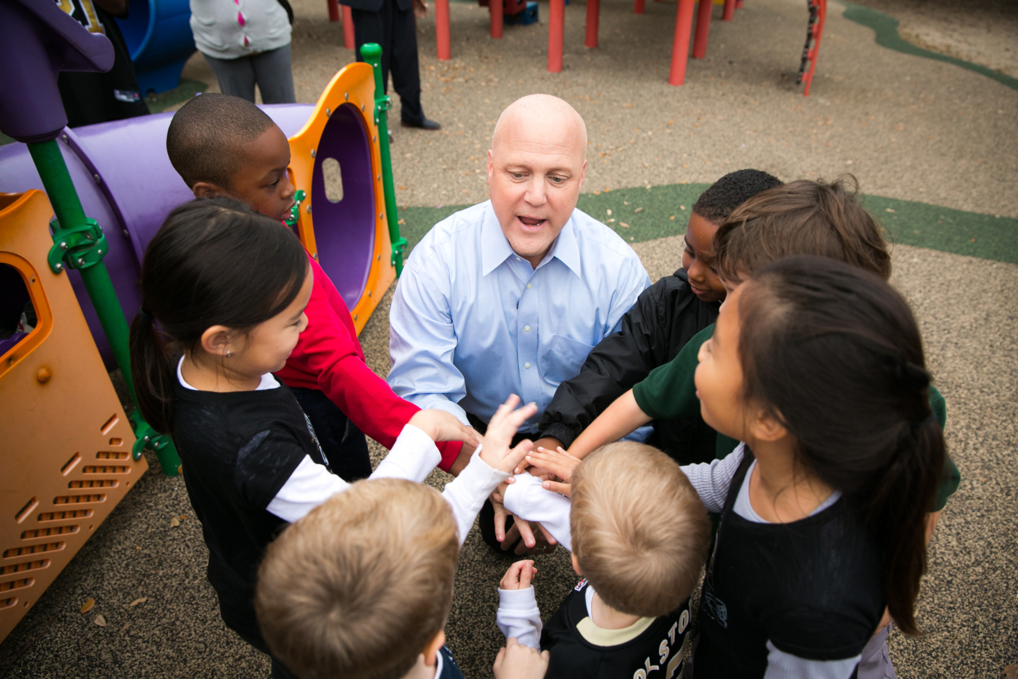 A man speaking with a group of children