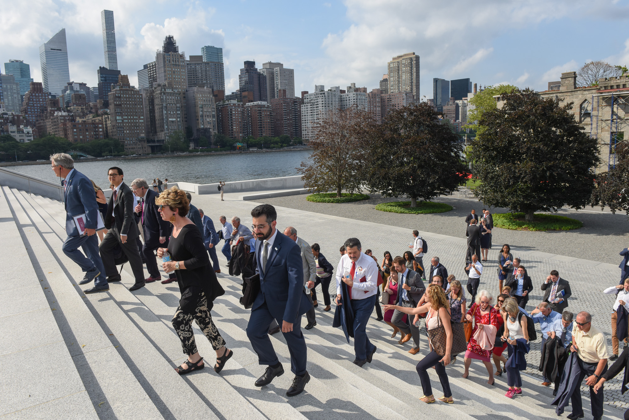 mayors walking up steps with the NY skyline in the background