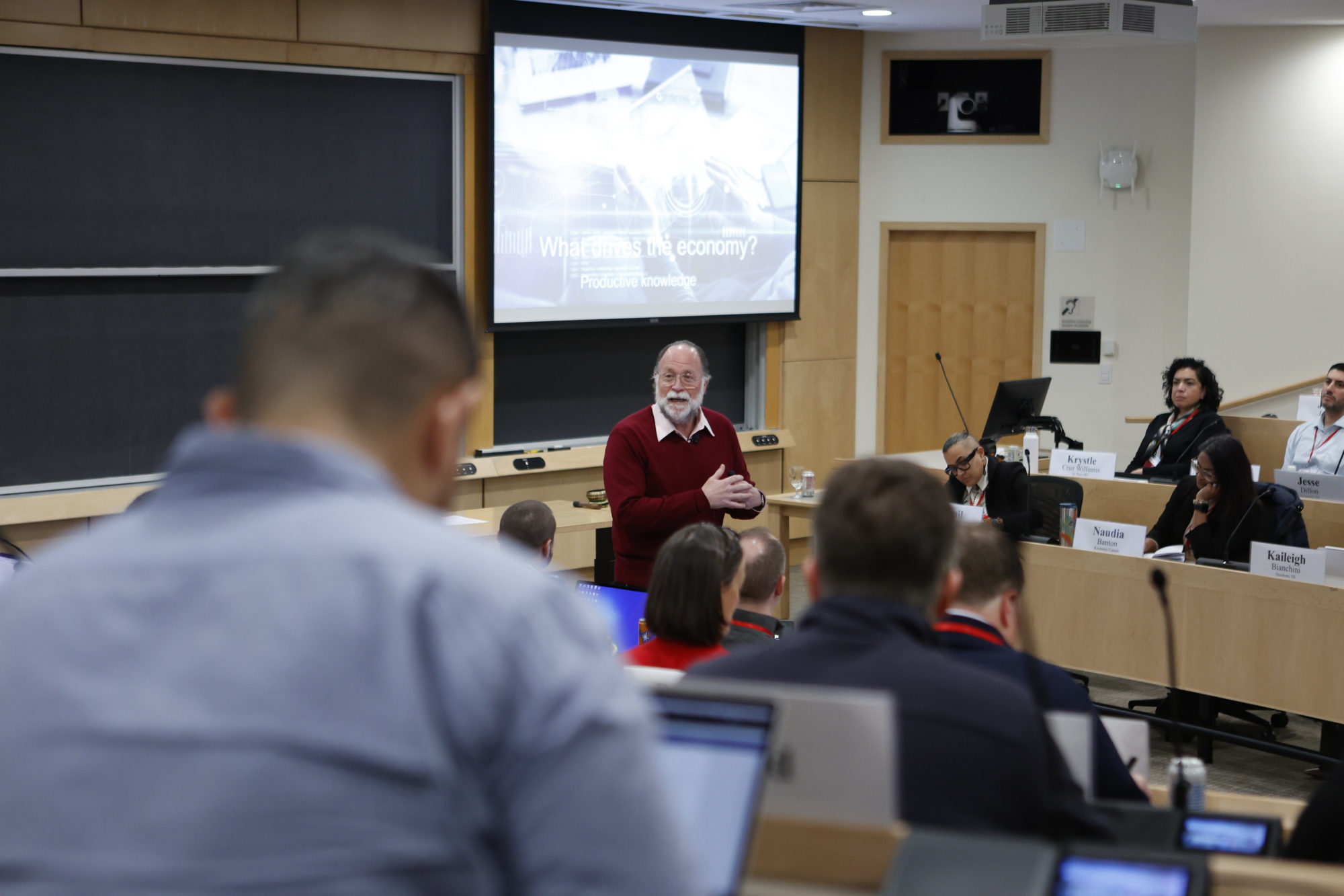 Professor teaching in a large classroom with students